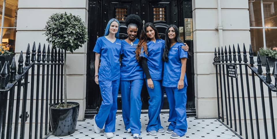 CoolSculpting fat freezing Dublin - four nurses in blue scrubs outside a Georgian clinic Four nurses in blue scrubs outside a Georgian clinic entrance for CoolSculpting fat freezing in Dublin